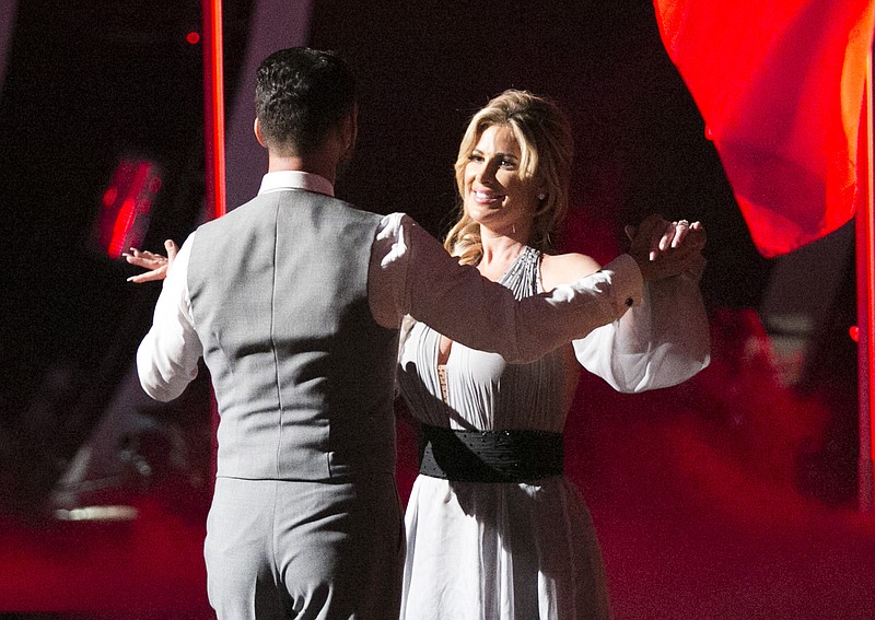 
              In this Sept. 22, 2015 photo released by ABC, Tony Dovolani, left, and Kim Zolciak Biermann perform on the celebrity dance competition series, "Dancing with the Stars," in Los Angeles.  Zolciak Biermann is the latest contestant who has injured themselves, either on, or while rehearsing for the show. She suffered a so-called "mini-stroke"  flying home from Los Angeles. (Adam Taylor/ABC via AP)
            