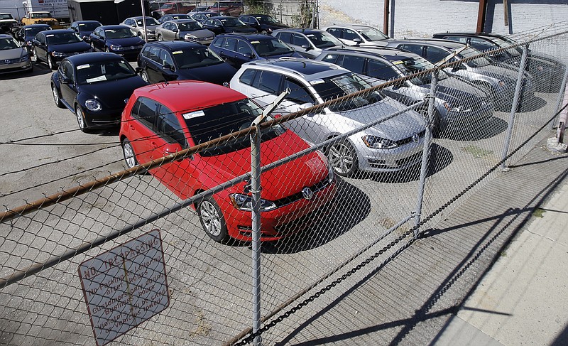 
              FILE - In this Sept. 23, 2015 file photo, diesel Volkswagens are seen behind a security fence on a storage lot near a VW dealership in Salt Lake City. Volkswagen is far from the first company to stand accused of trying to game required emissions tests. Almost since the passage of the Clean Air Act in 1970, major manufacturers of cars, trucks and heavy equipment have been busted for using what regulators call “defeat devices” _ typically programing a vehicle’s on-board computer to boost horsepower or fuel mileage by belching out dirtier exhaust than allowed. (AP Photo/Rick Bowmer, File)
            