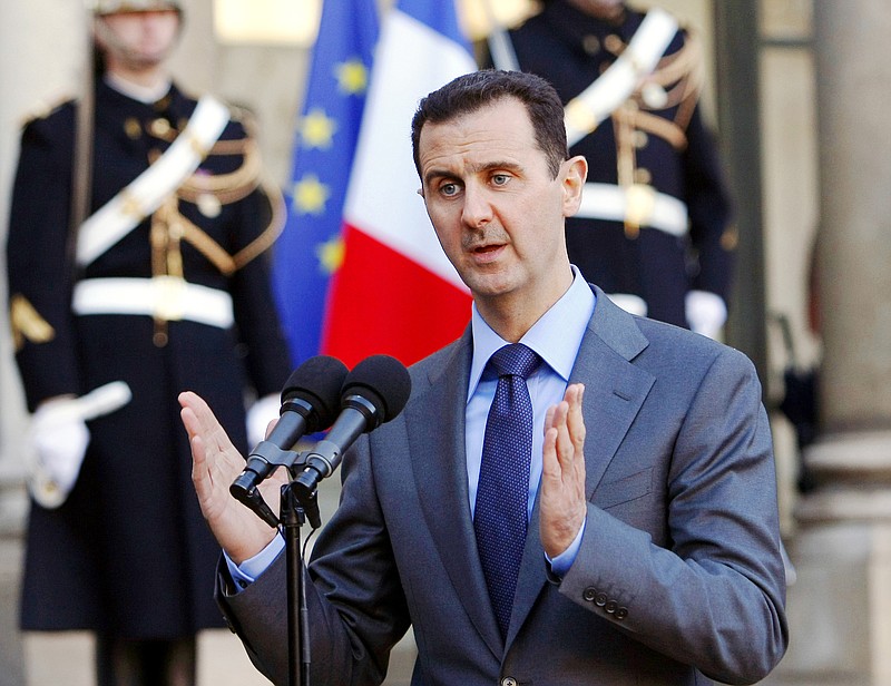 
              FILE - In this Thursday Dec. 9, 2010 file photo, Syria President Bashar al-Assad addresses reporters following his meeting with French President Nicolas Sarkozy at the Elysee Palace in Paris, France. Paris prosecutors have opened a preliminary investigation into French government accusations that Syrian President Bashar Assad's government has committed crimes against humanity. The prosecutor's office said Wednesday the investigation is based on photos taken by a former Syrian officer who fled in 2013 and focuses on atrocities allegedly committed between 2011 and 2013. (AP Photo/Remy de la Mauviniere, File)
            