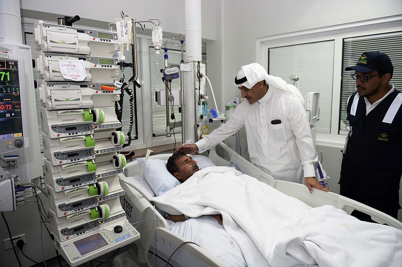 
              In this Tuesday, Sept. 29, 2015 photo provided by the Saudi state news agency Saudi Press Agency (SPA), an official from the Saudi Health Ministry talks to a victim who was injured in Thursday's stampede during the hajj pilgrimage in Mina, as he visits a hospital in Mecca, Saudi Arabia. Riyadh has said that more than 760 pilgrims died in the stampede near Mecca, the worst disaster to strike the annual pilgrimage in a quarter-century. (Saudi Press Agency via AP)
            