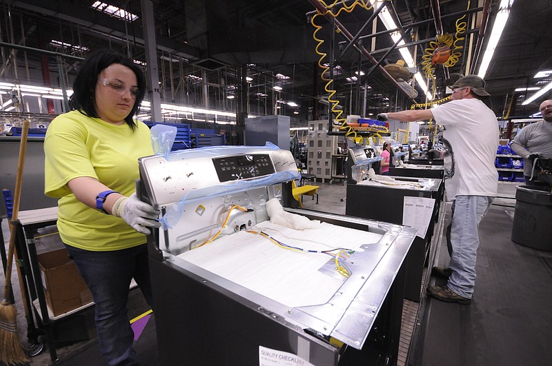 Tiffany Deberry attaches a range control panel in final assembly at Roper Corporation in LaFayette. The appliance manufacturer  has taken aggressive steps to promote wellness by creating an onsite medical and wellness center for their employees and families.