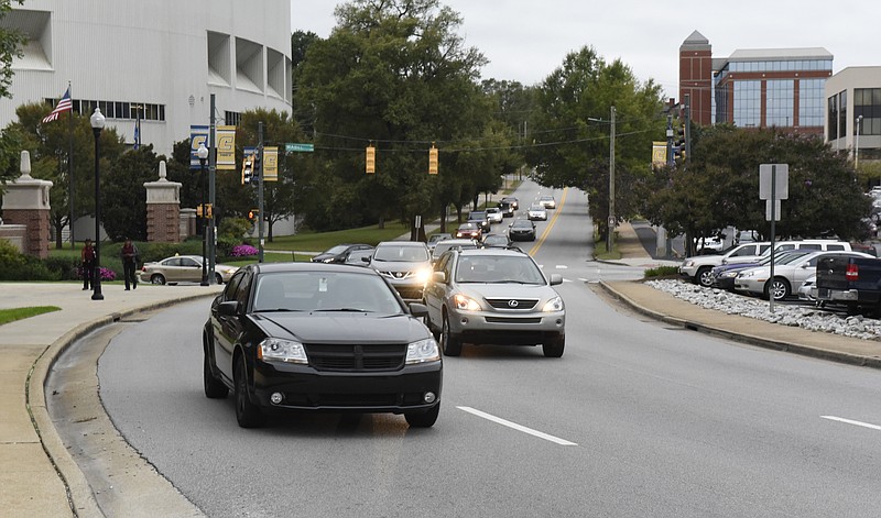 Eastbound Fourth Street traffic moves past the McKenzie Arena at UTC on Thursday, Oct. 1, 2015. The road becomes Third Street as it curves around the Chattanooga Citizens Cemetery.