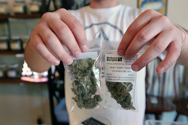 
              Associate Chris Hewitt holds up 7 gram bags of marijuana buds being prepared for sale at Nature Scripts medical marijuana dispensary in Murphy, Ore., Wednesday, Sept. 30, 2015. The dispensary is one of many across the state preparing for the first day of retail legal sales starting Thursday. (AP Photo/Jeff Barnard)
            