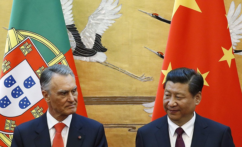 
              FILE - In this May 15, 2014, file photo, Portugal's President Anibal Cavaco Silva, left, and China's President Xi Jinping attend a signing ceremony at the Great Hall of the People in Beijing. When two Chinese companies appeared among the bidders to buy a troubled Portuguese bank this year, its staff took heart. They believed the potential buyers would do what Chinese investors are increasingly doing in Europe: save badly needed jobs and invest in expanding the business. (Kim Kyung-hoon/Pool Photo via AP)
            