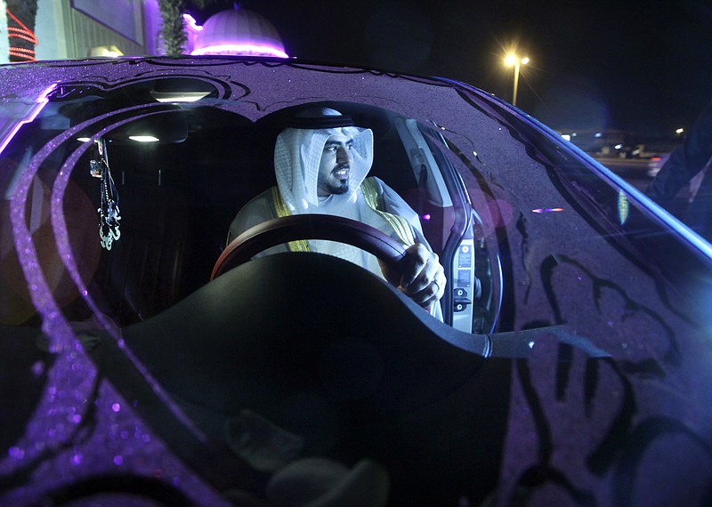 
              In this Tuesday, Sept. 8, 2015, photo, Saudi groom Hisham Saleh Edris drives his decorated car as he arrives alone at the men's section of the wedding hall in Jiddah, Saudi Arabia. A drop in oil revenue is forcing Saudi Arabia to weigh its first cuts to welfare and investment in years. (AP Photo/Amr Nabil)
            