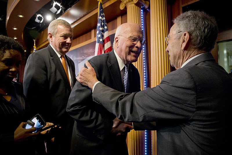 
              Senate Judiciary Committee Chairman Sen. Charles Grassley, R-Iowa, right, shakes hands with the committee's ranking member Sen. Patrick Leahy, D-Vt., during a news conference on Capitol Hill in Washington, Thursday, Oct. 1, 2015, where a bipartisan group of Senators spoke about criminal justice reform. The group unveiled legislation that would overhaul the nation’s criminal justice system, allowing some non-violent drug offenders to get reduced prison sentences and giving judges greater discretion in sentencing.. Senate Minority Whip Richard Durbin of Ill. is at left.  (AP Photo/Jacquelyn Martin)
            