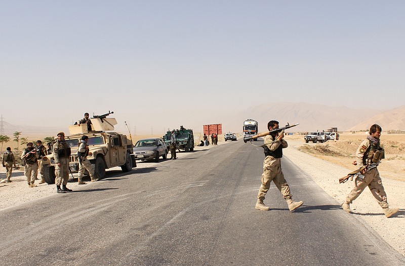 Afghanistan's security forces take their position during a clash by Taliban fighters in the highway between Balkh province to Kunduz city, north of Kabul, Afghanistan, Thursday, Sept. 1, 2015. 