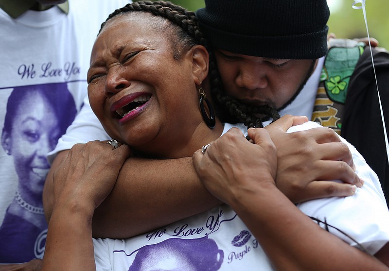 Family gather for vigil for woman fatally shot while driving