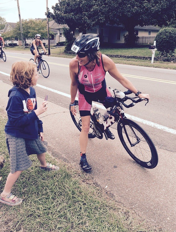 Karah Nazor stops along the Ironman bike route to talk to her niece, Tilleigh.