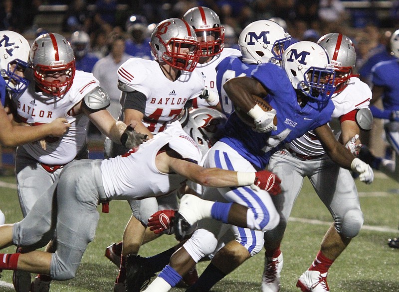 In this 2014 file photo, McCallie School's Alex Trotter pushes forward as Baylor defenders attempt to slow him during the rival game.