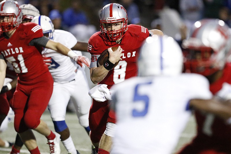 Baylor School quarterback Wil Austin (8) runs the ball past McCallie School defenders to score a touchdown during the first half of play at the Red Raider's home field on October 2, 2015.