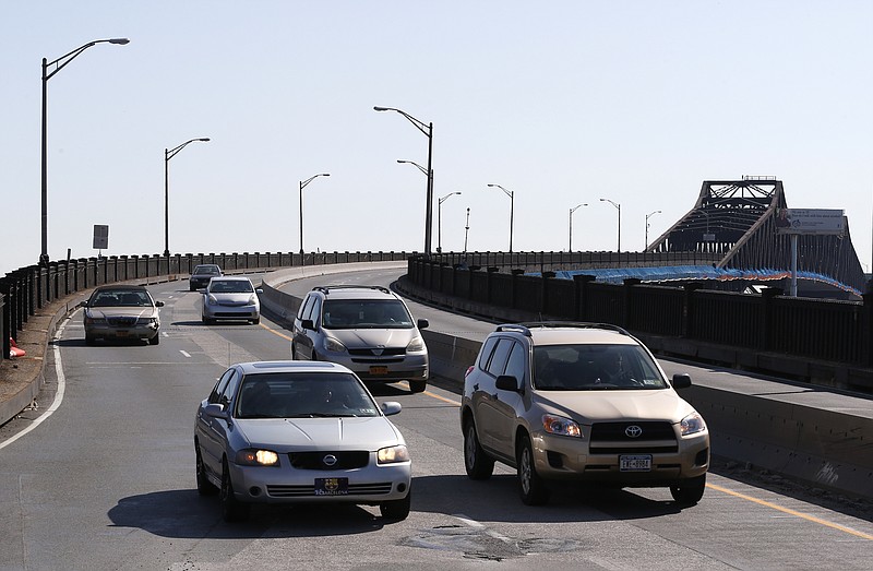 
              FILE - In this April 12, 2014, file photo, vehicles drive on the southbound side of the Pulaski Skyway while the northbound side is closed off to traffic on the first day of the bridge's two-year closure in Newark, N.J. Documents obtained by The Associated Press offer a peek into the legal strategies being explored by officials for the Port Authority of New York and New Jersey who are under investigation for a controversial decision to divert $1.8 billion from a rail project to state highway repairs. The Manhattan district attorney and the Securities and Exchange Commission have both been examining whether the Port Authority misled bondholders when it used the money on state roads it didn’t own, including the Pulaski Skyway, an elevated road connecting two New Jersey cities, Newark and Jersey City. (AP Photo/Julio Cortez, File)
            