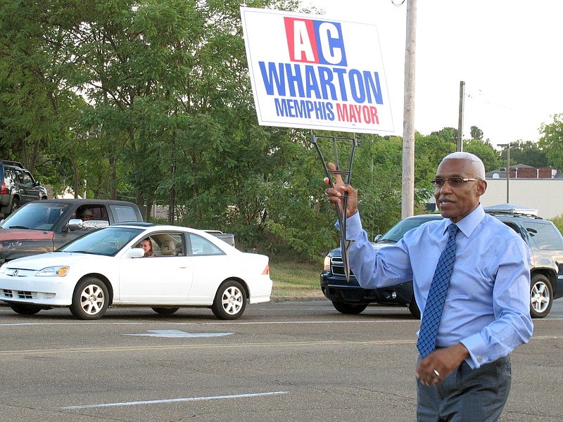 
              In this photo taken on Friday, Sept. 25, 2015, Memphis Mayor A C Wharton Jr. holds a campaign sign on a street corner in Memphis, Tenn. Wharton is seeking re-election as the city's mayor. (AP Photo/Adrian Sainz)
            