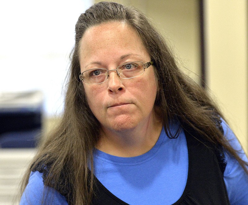 
              FILE - In this Tuesday, Sept. 1, 2015, file photo, Rowan County Clerk Kim Davis listens to a customer following her office's refusal to issue marriage licenses at the Rowan County Courthouse in Morehead, Ky. Davis, who spent five days in jail for defying a series of federal court orders, filed a lawsuit against Gov. Steve Beshear, alleging he violated her religious freedom by asking clerks to comply with the U.S. Supreme Court's decision, which effectively legalized gay marriage across the nation. Beshear reiterated a request Tuesday, Sept. 29, that a judge toss the suit. (AP Photo/Timothy D. Easley, File)
            