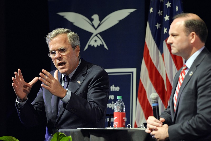 Republican presidential candidate Jeb Bush, left, speaks at Furman University in Greenville, S.C., Friday, Oct. 2, 2015. South Carolina Attorney General Alan Wilson moderated the event.