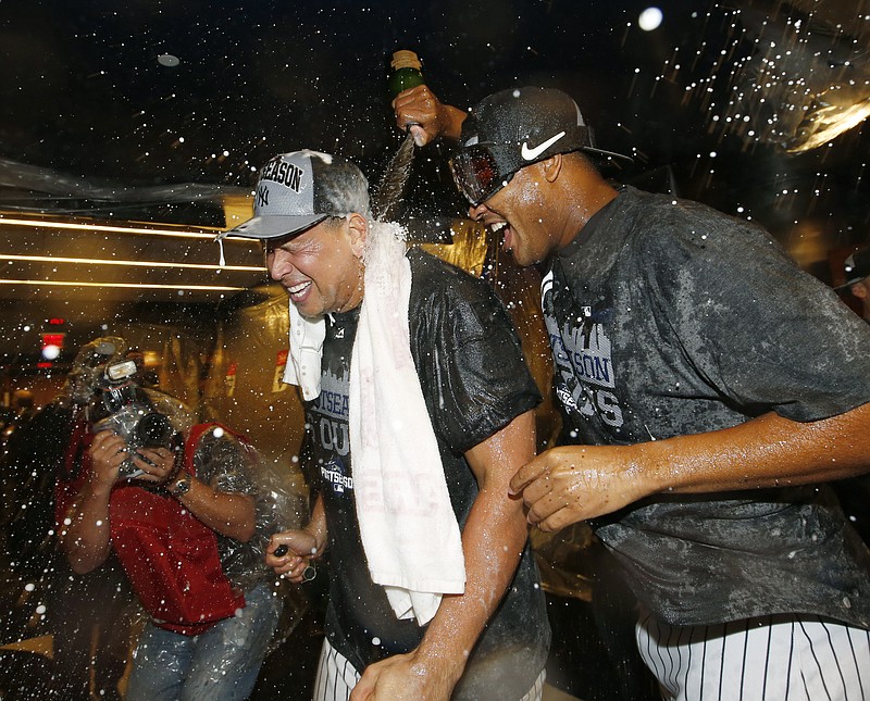 New York Yankees pitcher Ivan Nova, left, pours champagne on New York Yankees designated hitter Alex Rodriguez as the Yankees celebrated their 4-1 victory over the Boston Red Sox to clinch a wild card berth in the playoffs after a baseball game in New York, Thursday, Oct. 1, 2015. 