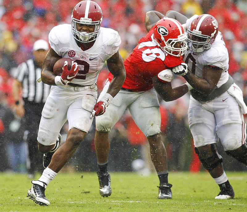 Alabama's Derrick Henry (2) runs for a touchdown as offensive lineman Alphonse Taylor (50) blocks Georgia defensive tackle Trenton Thompson in the first half of the Crimson Tide's 38-10 victory Saturday in Athens, Ga.