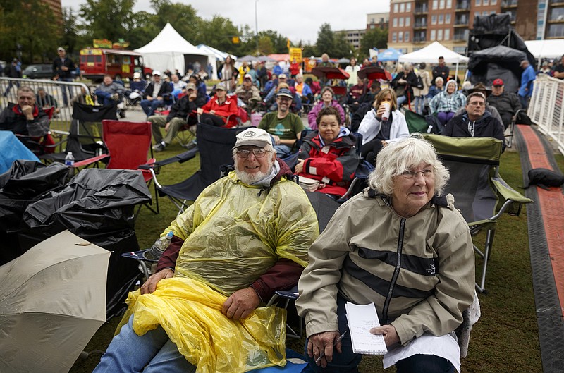 Henry Snyder, left, and Marcia Winters watch Lone Mountain Band perform during the 3 Sisters Bluegrass Festival at Ross's Landing on Saturday, Oct. 3, 2015, in Chattanooga, Tenn. Inclement weather didn't stop bluegrass fans from attending the 9th edition of the festival, which was named one of the nation's top bluegrass gatherings by Great American Country.