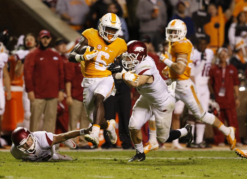 Staff Photo by Dan Henry / The Chattanooga Times Free Press- 10/3/15. UT's Alvin Kamara (6) leaps over Arkansas defenders to run the ball into the end zone before realizing a flag had been thrown during the second quarter of play on October 3, 2015. The Volunteers played the Razorbacks at home in Neyland Stadium late Saturday evening. 