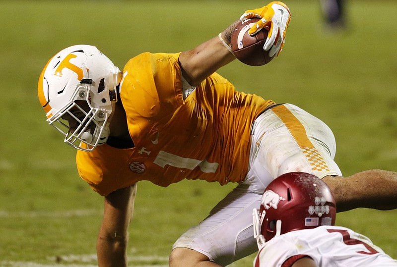 Tennessee running back Jalen Hurd is tripped up by the Arkansas Razorbacks' Henre' Toliver during the fourth quarter of Saturday night's Southeastern Conference matchup at Neyland Stadium. The Volunteers lost 24-20 after being tied at 17 at halftime.