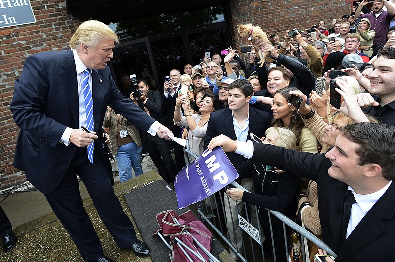 
              Republican presidential candidate Donald Trump signs autographs after speaking to campaign supporters, Saturday, Oct. 3, 2015, in Franklin, Tenn. (AP Photo/Mark Zaleski)
            