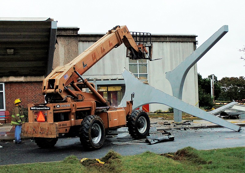
              The remains of a concrete canopy that collapsed sit in front of North Iredell High School on Saturday, Oct. 3, 2015, in Olin, N.C. A box truck hit one of the canopy supports and the awning then fell on a group of band students. (AP Photo/Skip Foreman)
            
