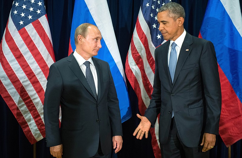 
              FILE - In this Monday, Sept. 28, 2015 file photo, U.S. President Barack Obama, right, and Russia's President Vladimir Putin pose for members of the media before a bilateral meeting at the United Nations headquarters. (Sergey Guneyev/RIA-Novosti, Kremlin Pool Photo via AP)
            