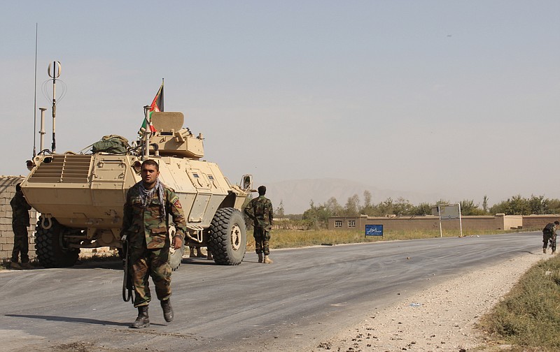 Afghan security forces take their position during a clash by Taliban fighters in the highway between Baghlan to Kunduz city, north of Kabul, Afghanistan, Friday, Oct. 2, 2015. 