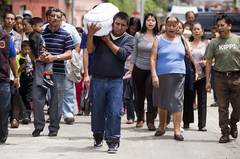 Welsar Nazario carries the coffin of his five-month-old nephew Alezandro Macario, who died in a mudslide, to the Santa Catarina Pinula cemetery on the outskirts of Guatemala City, Saturday, Oct. 3, 2015. Rescue workers recovered more bodies early Saturday after a hillside collapsed on homes on Thursday night, while more are feared still buried in the rubble.