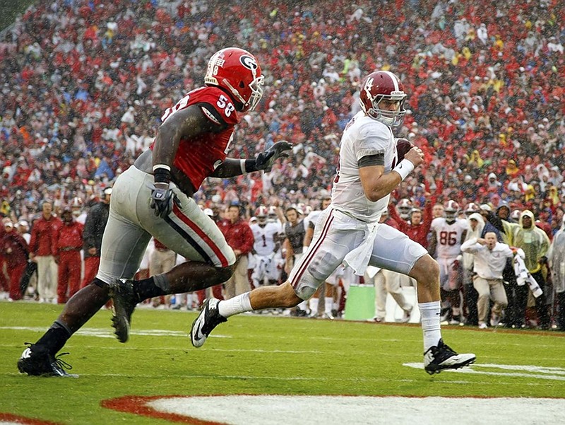 Alabama quarterback Jake Coker, right, outruns Georgia defensive tackle Sterling Bailey to score a touchdown during the Crimson Tide's 38-10 rout of the Bulldogs on Saturday in Athens, Ga.