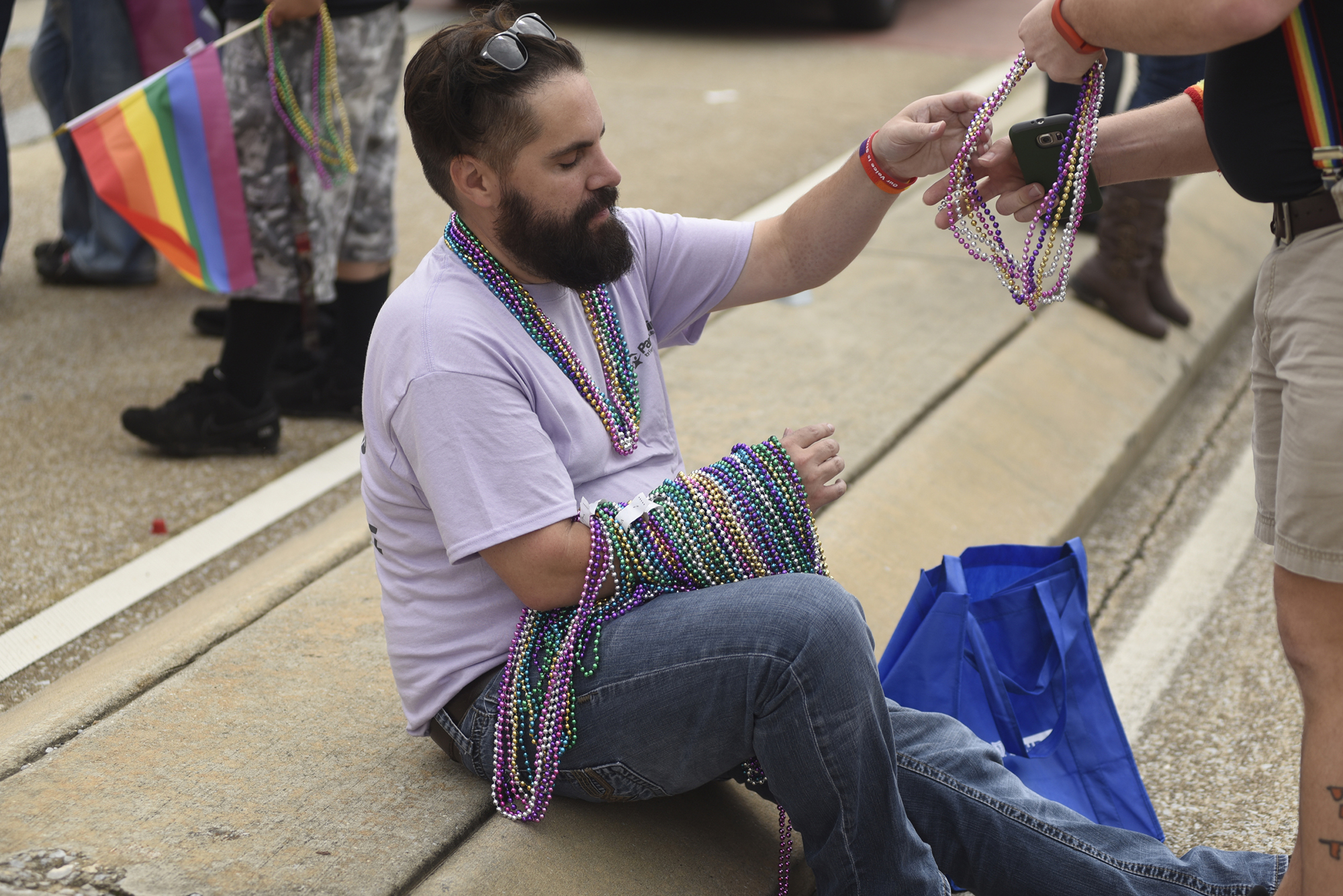 Chris Berryman hands out beads during the Chattanooga Pride Festival on Riverfront Parkway on Sunday, Oct. 4, 2015., in Chattanooga, Tenn.