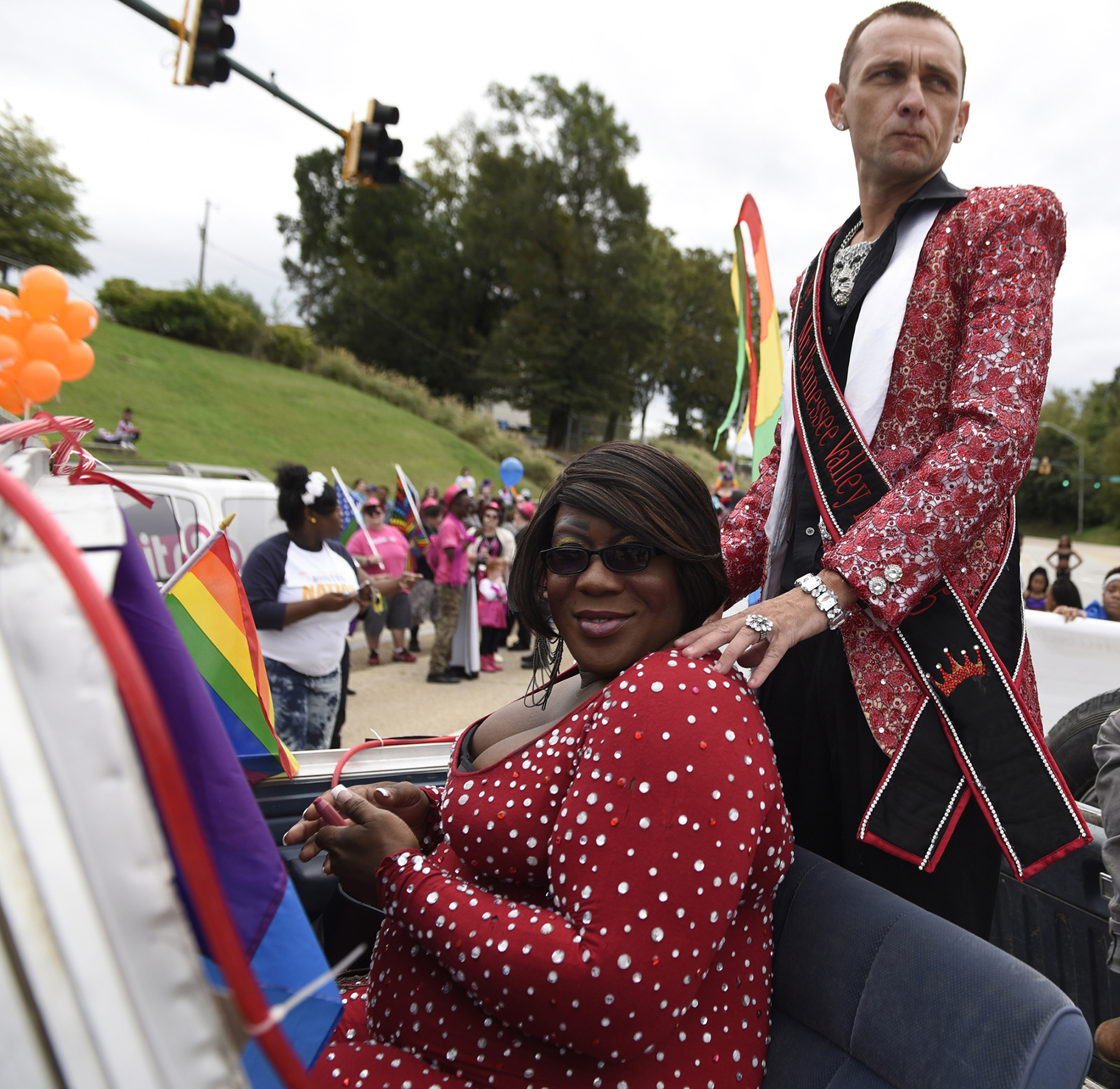 Austin St. James, standing, and Luscia Montice, Mr. and Miss Tennessee Valley Pride, ride in a vehicle during the Chattanooga Pride Festival parade on Riverfront Parkway on Sunday, Oct. 4, 2015., in Chattanooga, Tenn.