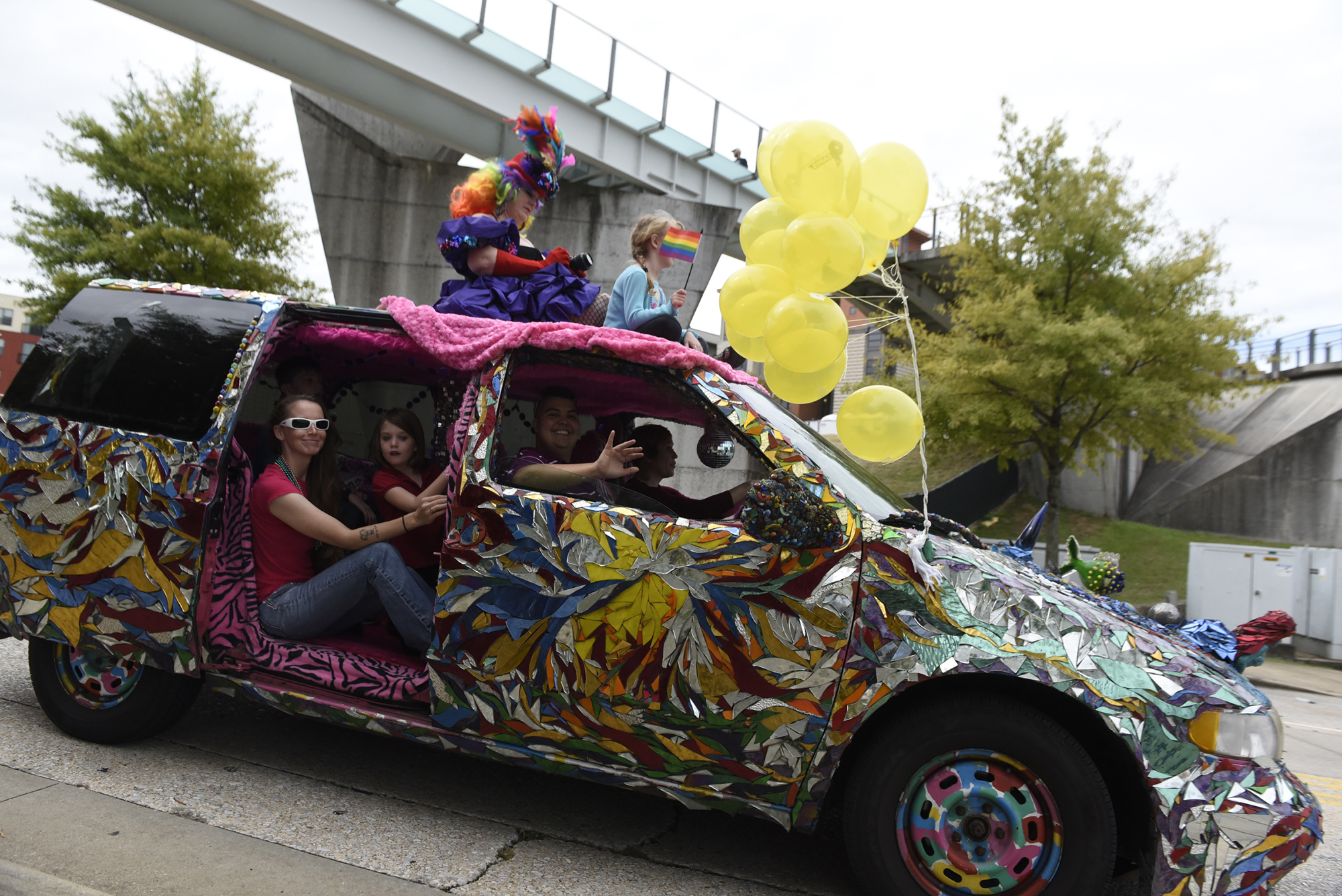 Wendy Tippens, left, rides atop her art car, the Love Van, with Kaylee Serna sitting next to her during the Chattanooga Pride Festival parade on Riverfront Parkway on Sunday, Oct. 4, 2015., in Chattanooga, Tenn.