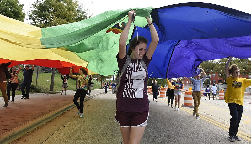 Briana Smith helps others carry a giant rainbow flag during the Chattanooga Pride Festival parade on Riverfront Parkway on Sunday, Oct. 4, 2015., in Chattanooga, Tenn.