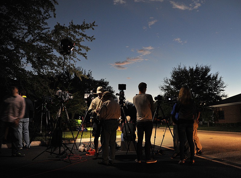 
              As the sun begins to set as television crews set up their lights while waiting for an update on the crew members aboard the missing cargo ship El Faro outside the Seafarer's International Union hall in Jacksonville, Fla., Sunday, Oct. 4, 2015. Authorities lost contact with the El Faro early Thursday as the ship sailed through the Bahamas at the height of the Hurricane Joaquin storm as it sailed from its homeport in Jacksonville, Fla., to San Juan, Puerto Rico. (Bruce Lipsky/The Florida Times-Union via AP) MANDATORY CREDIT
            