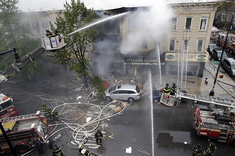 
              Firefighters work at the at the scene of an explosion at a three-story building in the Borough Park neighborhood in the Brooklyn borough of New York, Saturday, Oct. 3, 2015. Fire Commissioner Daniel Nigro says the explosion apparently happened after a stove was disconnected. (AP Photo/Mary Altaffer)
            