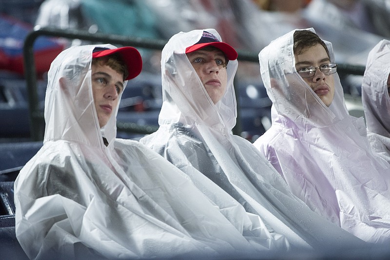 Fans wait for a baseball game between the Atlanta Braves and the St. Louis Cardinals which a was delayed because of rain, Saturday, Oct. 3, 2015, in Atlanta. 