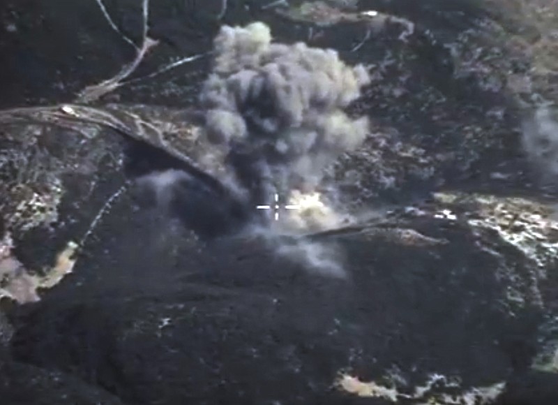 In this photo made from the footage taken from Russian Defense Ministry official web site on Sunday, Oct. 4, 2015, an aerial view of a bomb explosion in Syria. According to information released by the Russian Defense Ministry, Russian aircraft have carried out 20 sorties in Syria in the past 24 hours. 