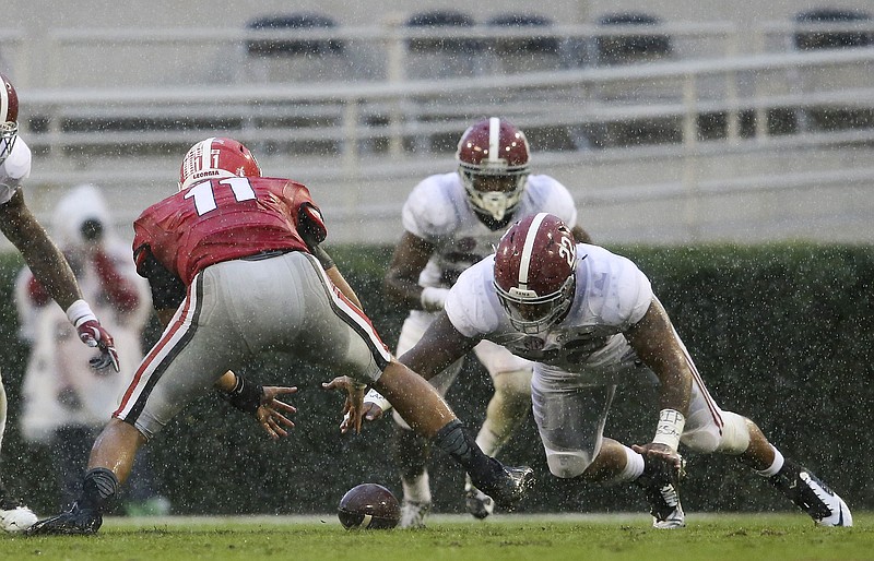 Alabama linebacker Ryan Anderson dives on a fumble by Georgia quarterback Greyson Lambert during the Crimson Tide's 38-10 win in Athens last Saturday. The eighth-ranked Tide host Arkansas this week.