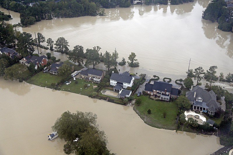 Floodwaters close in on homes on a small piece of land on Lake Katherine in Columbia, S.C., Monday, Oct. 5, 2015.