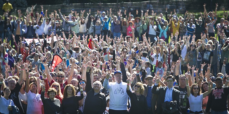 
              A crowd gathered in Central Park to form a human peace sign to remember John Lennon and attempt a Guinness world record, raises their hands in a peace sign gesture, Tuesday, Oct. 6, 2015, in New York. Thousands of people joined Yoko Ono and tried to set a world record for largest group of human bodies forming a peace sign. The record attempt to honor Ono's husband, John Lennon, didn't succeed. Lennon would have turned 75 on Friday.   (AP Photo/Bebeto Matthews)
            