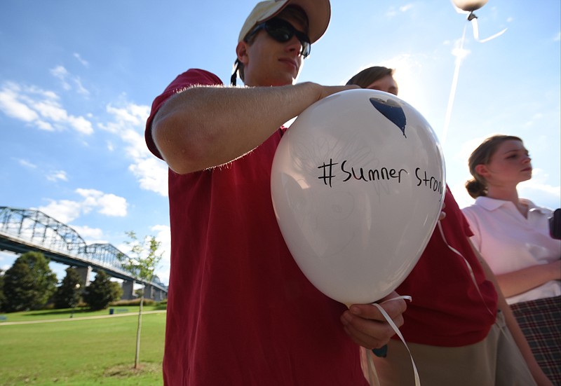 Parrish Pettway holds his "#Sumner Strong" balloon Monday before the release at 4:30 p.m. at Coolidge Park.