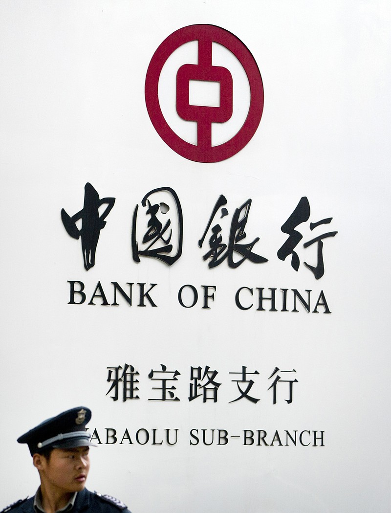 
              FILE - In this May 11, 2015 file photo, a security guard stands outside a Bank of China branch in Beijing. A New York judge has ordered the Bank of China to hand over detailed information about Chinese bank accounts used by a counterfeiting ring that allegedly sold millions of dollars of fake Gucci handbags and wallets in the U.S. (AP Photo/Mark Schiefelbein, File)
            