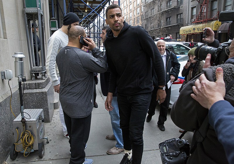 In this photo from Wednesday, April 8, 2015, Atlanta Hawks forward Thabo Sefolosha, center, leaves a courthouse in New York.