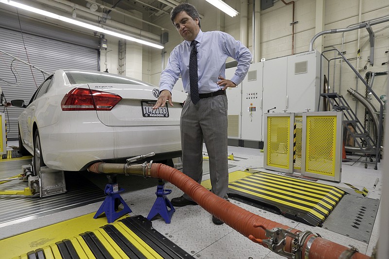 In this Sept. 30, 2015, photo, John Swanton, spokesman with the California Air Resources Board explains how a 2013 Volkswagen Passat with a diesel engine is evaluated at the emissions test lab in El Monte, Calif. 