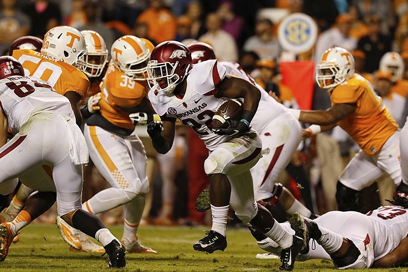 Arkansas running back Rawleigh Williams III finds a gap in the Tennessee defense during the second quarter Saturday at Neyland Stadium. The Volunteers allowed Williams and Razorbacks running back Alex Collins to each rush for more than 100 yards as Arkansas won 24-20.