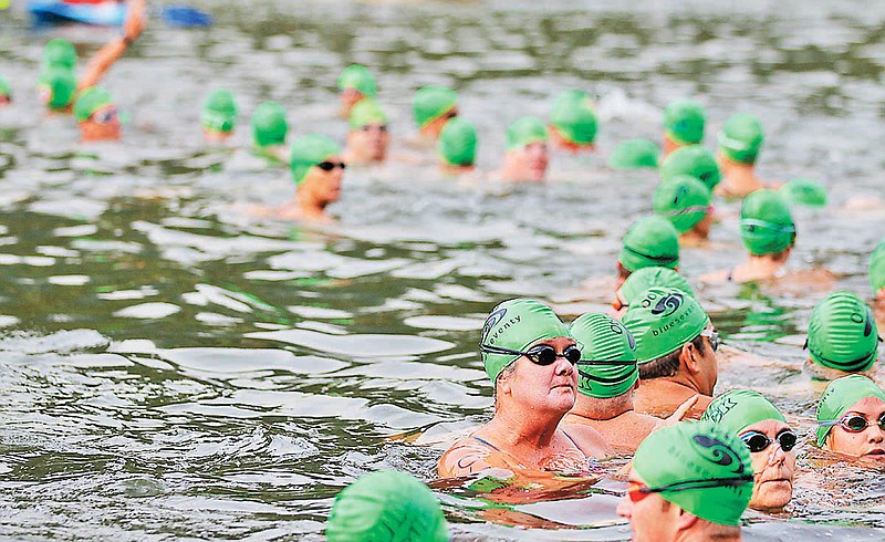 Swimmers wait at the starting rope as the announcer counts down to the start of the race at the Swim the Suck event held on Suck Creek in Chattanooga.