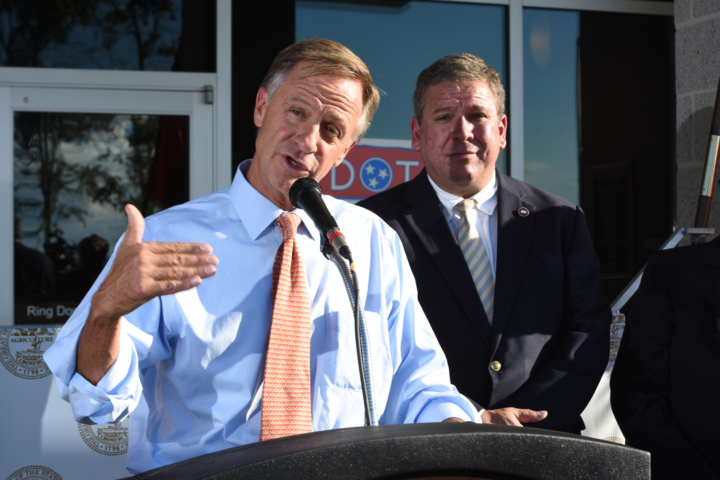 Tennessee Governor Bill Haslam talks about the commitment the state has to Volkswagen Wednesday outside the Tennessee Department of Transportation Management Center in Chattanooga. Tennessee General Assembly House Speaker Gerald McCormick listens, back right. The governor had just come from visiting with workers inside the plant Wednesday afternoon, Oct. 7, 2015.