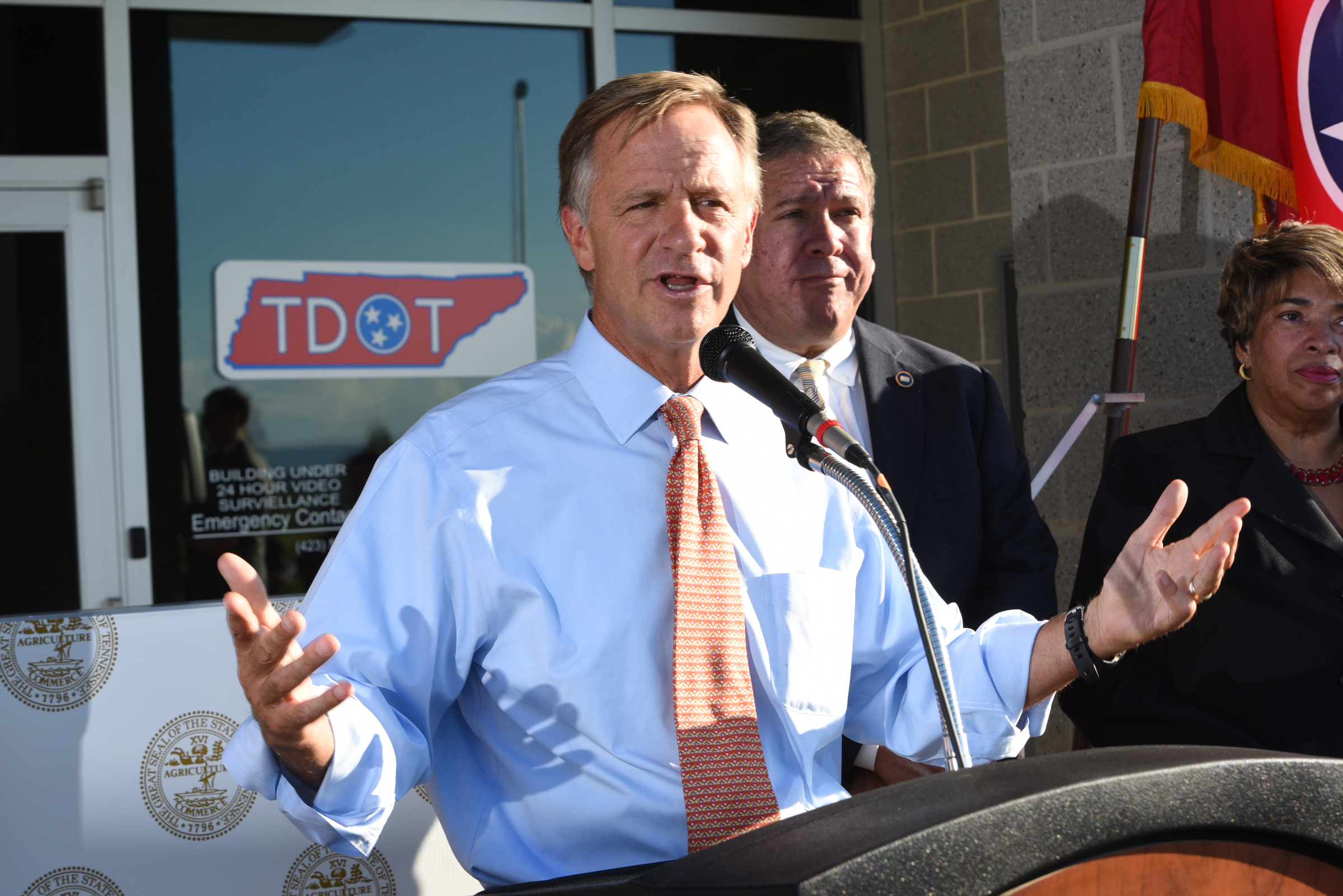 Tennessee Governor Bill Haslam talks about the commitment the state has to Volkswagen Wednesday outside the Tennessee Department of Transportation Management Center in Chattanooga. Tennessee General Assembly House Speaker Gerald McCormick listens, back right. The governor had just come from visiting with workers inside the plant Wednesday afternoon, Oct. 7, 2015.