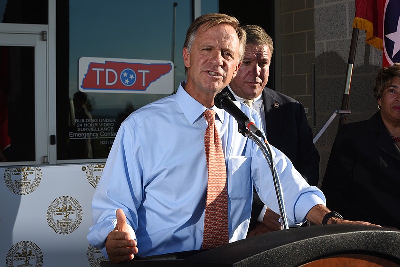 Tennessee Governor Bill Haslam talks about the commitment the state has to Volkswagen Wednesday outside the Tennessee Department of Transportation Management Center in Chattanooga. Tennessee General Assembly House Speaker Gerald McCormick listens, back right. The governor had just come from visiting with workers inside the plant Wednesday afternoon, Oct. 7, 2015.